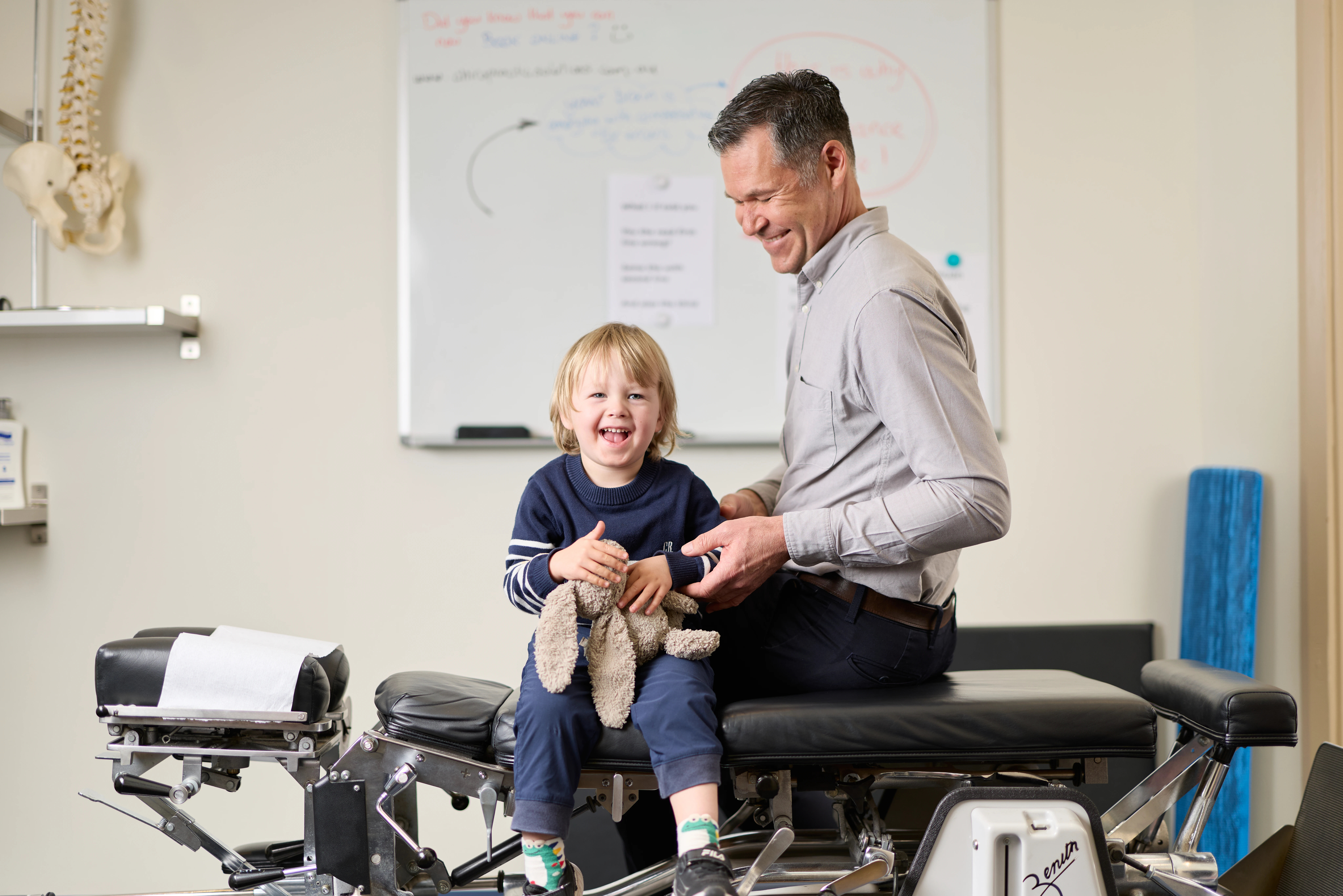 Dr Andrian Turczynowicz, chiropractor treating a toddler at Chiropractic Solutions Norwood Adelaide