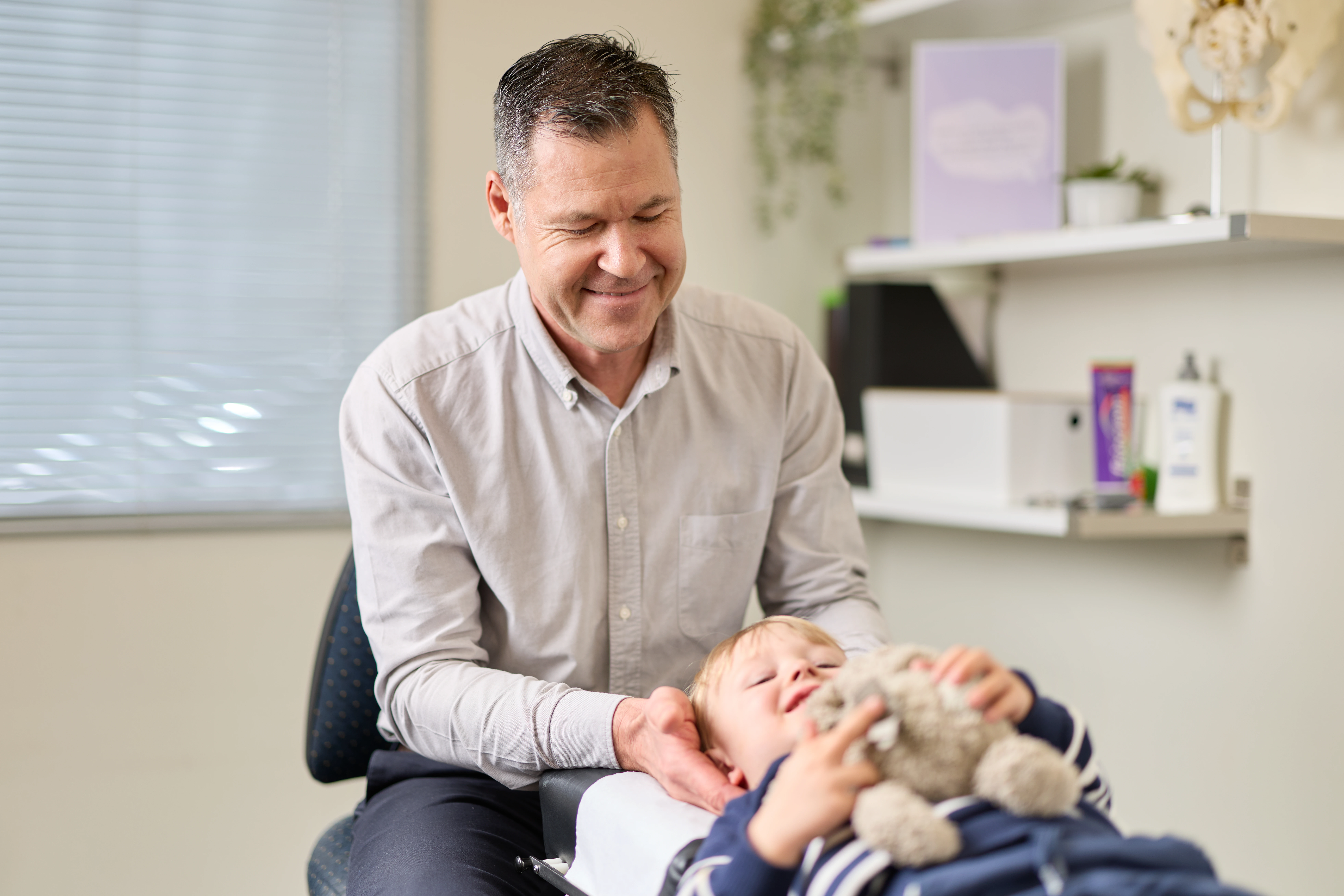 A young child being adjusted by Dr Andrian Turczynowicz, chiropractor at Norwood Adelaide