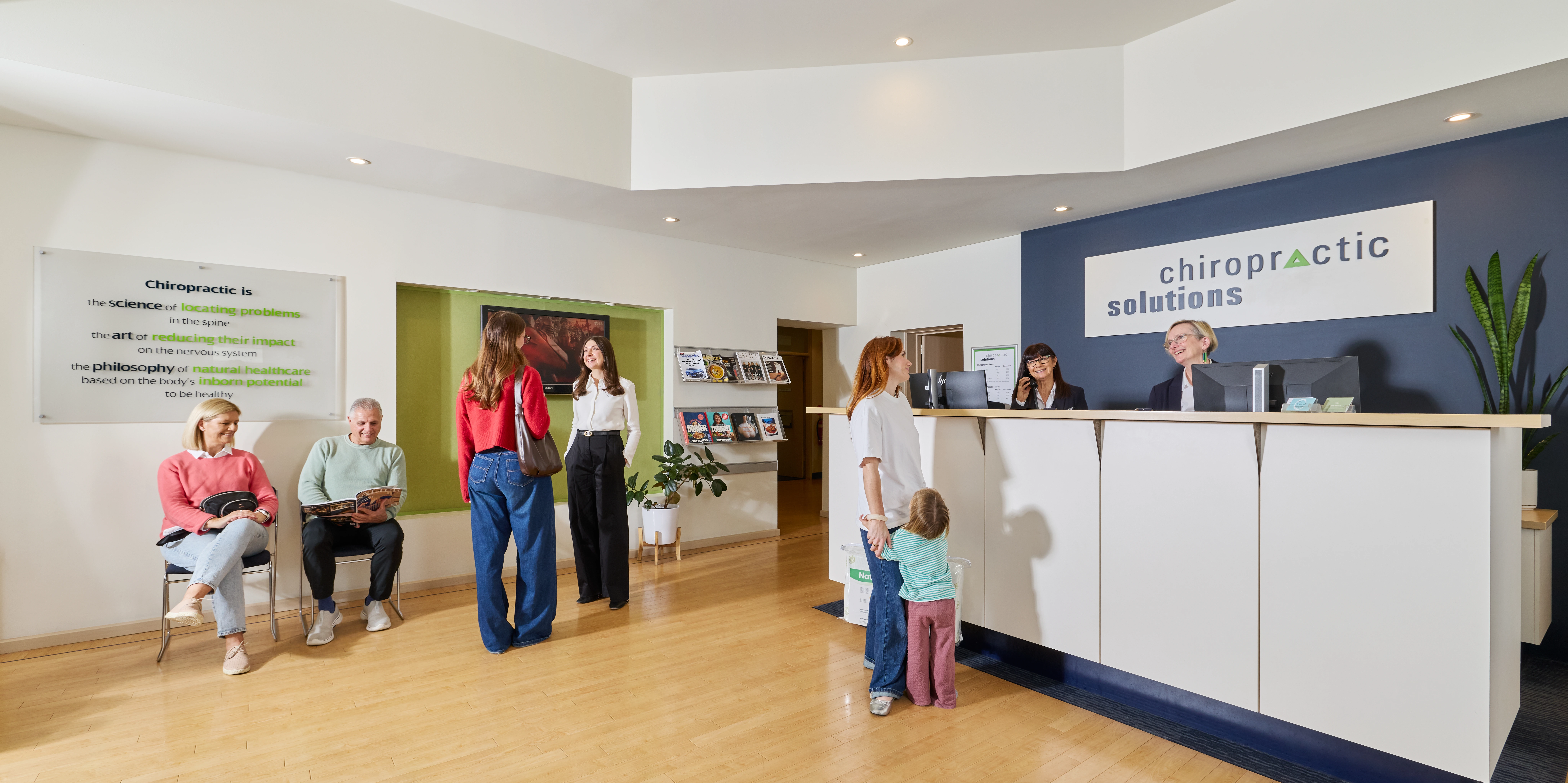 Reception area with people sitting and standing at Chiropractic Solutions in Norwood Adelaide