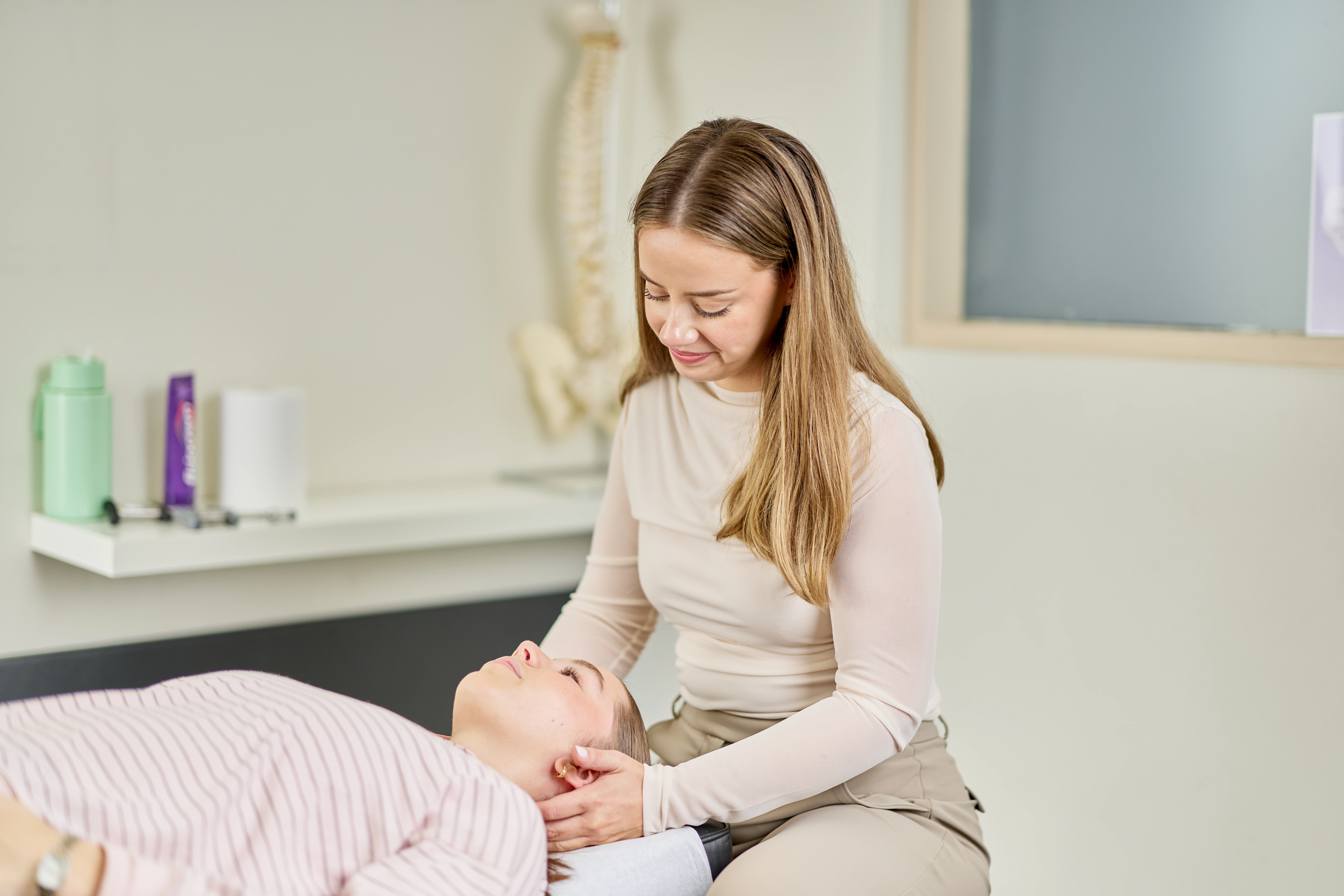 Dr Taylor Upton, chiropractor treating a teenage female at Chiropractic Solutions Norwood Adelaide
