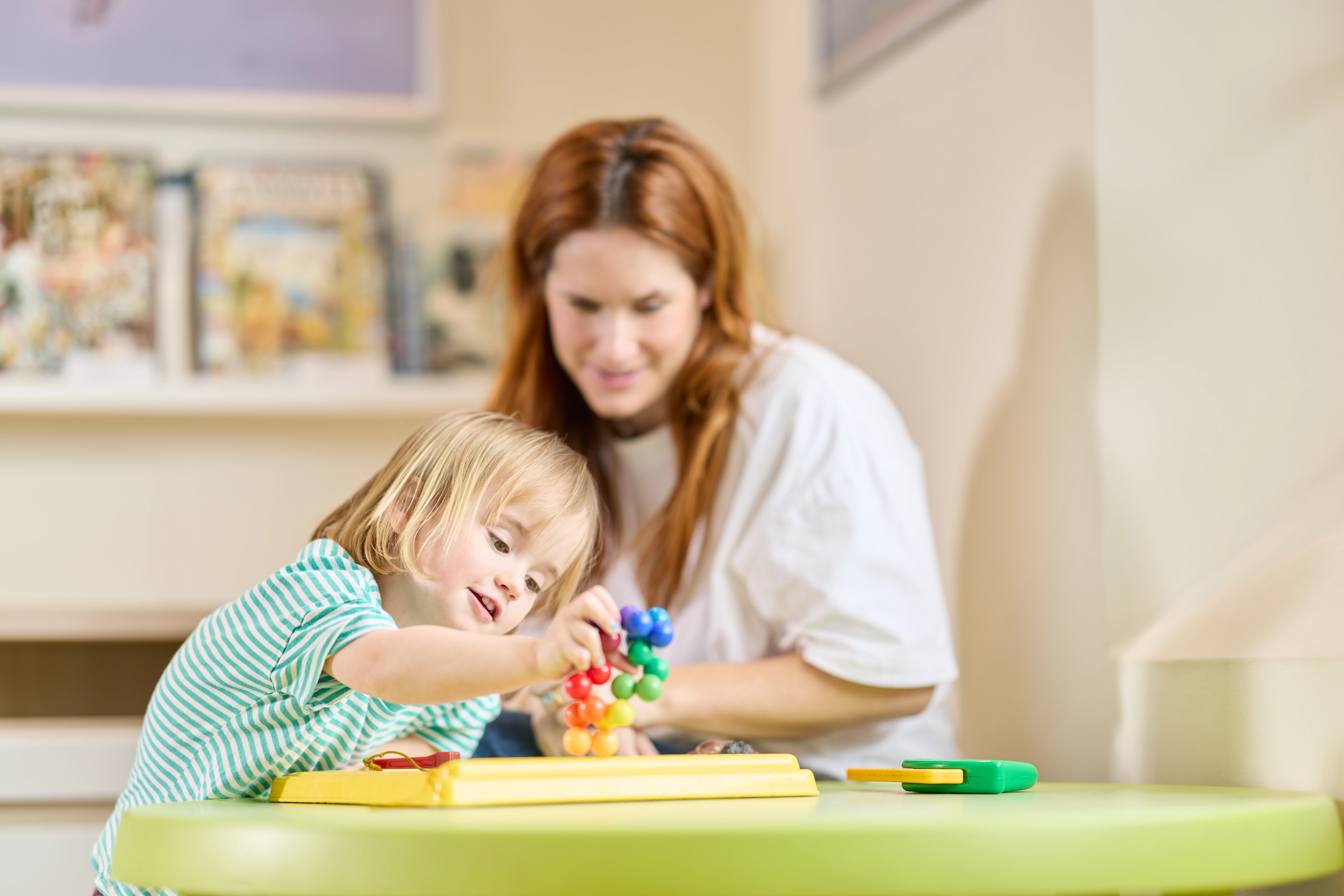 Little girl sitting playing at the children's table at Chiropractic Solutions Norwood Adelaide