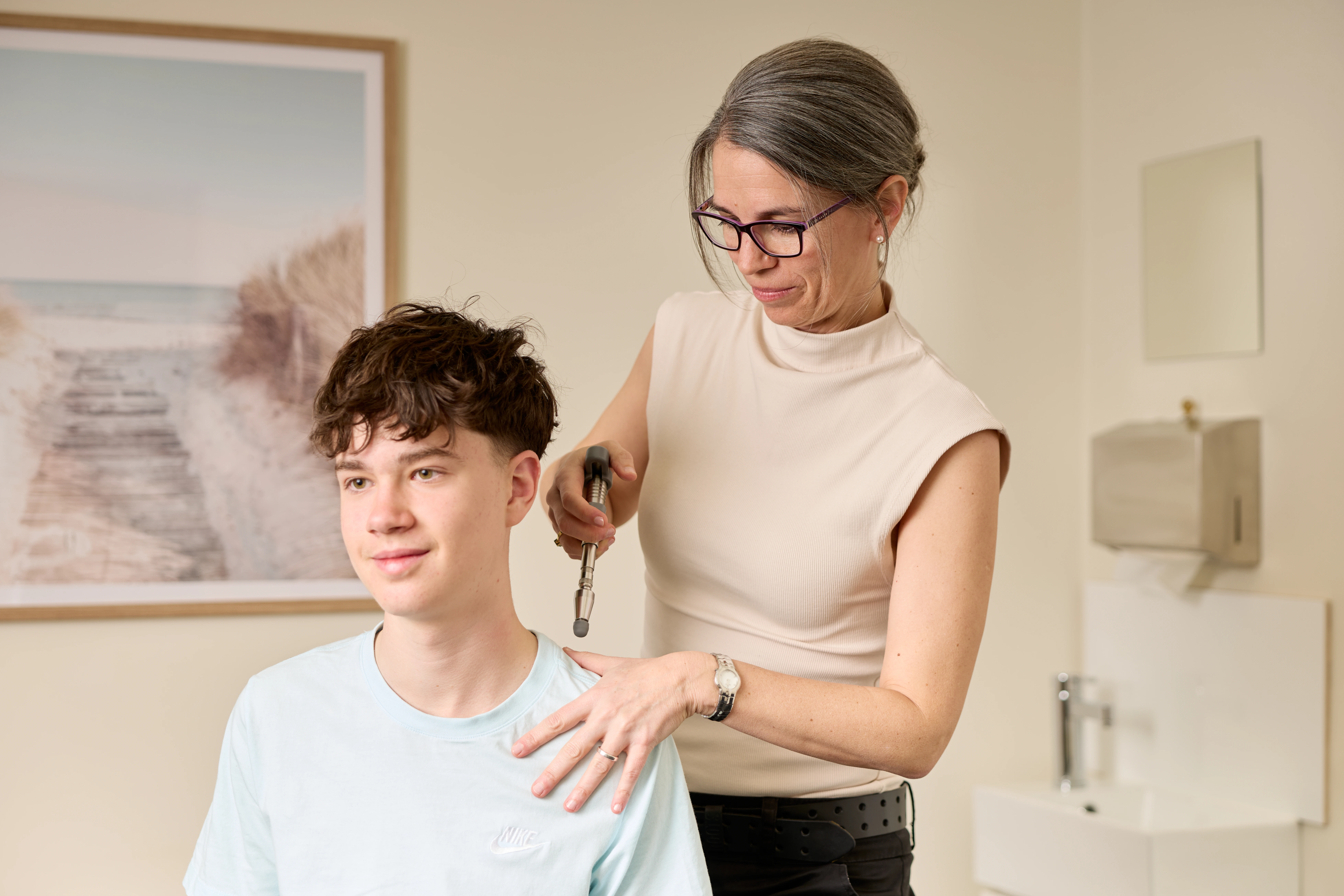 A teenager receiving a shoulder treatment from Dr Adrienne Wilson  chiropractor at Norwood Adelaide