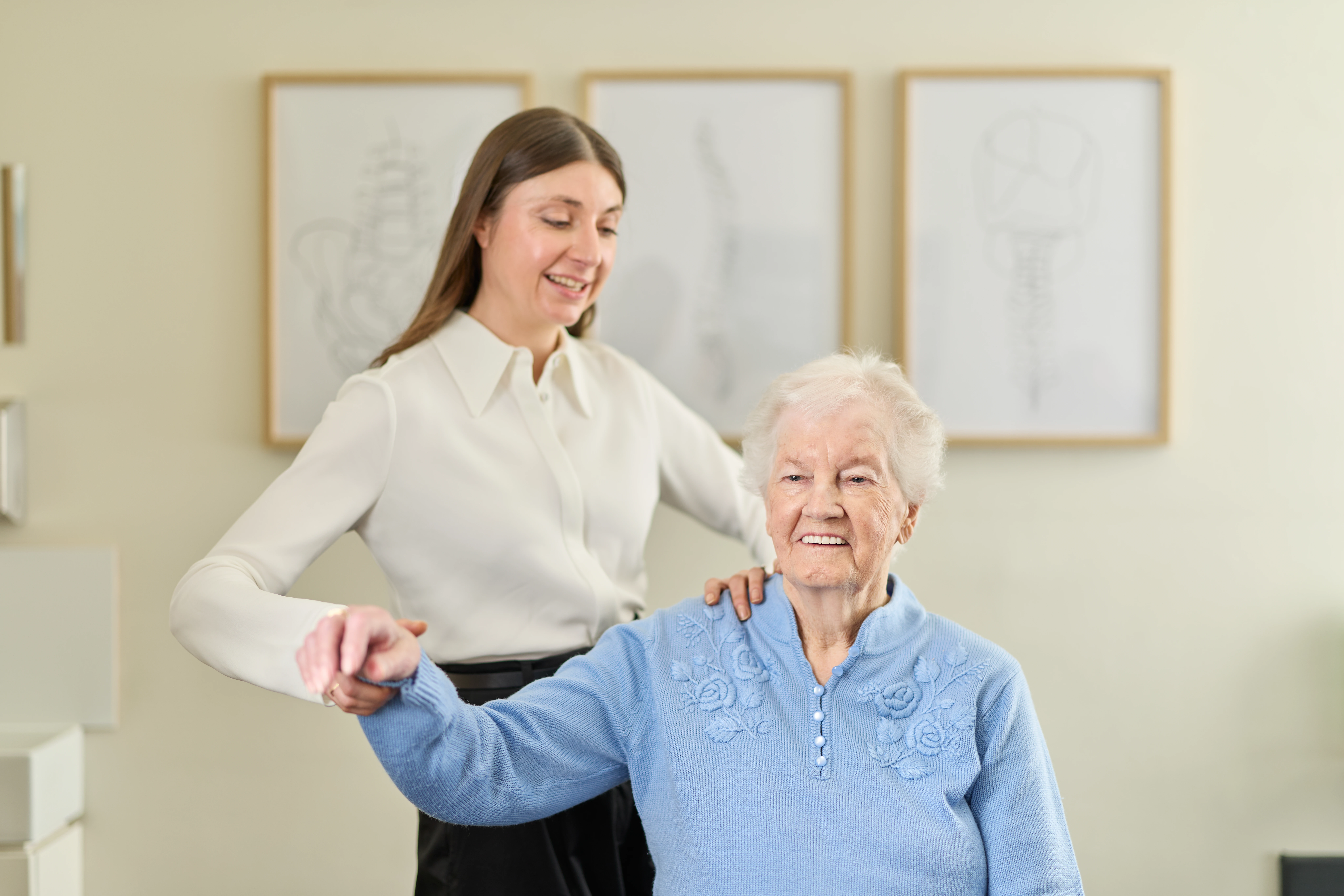 Dr Kimberley Manz, chiropractor, giving a shoulder treatment to an elderly female patient at Chiropractic Solutions Norwood Adelaide