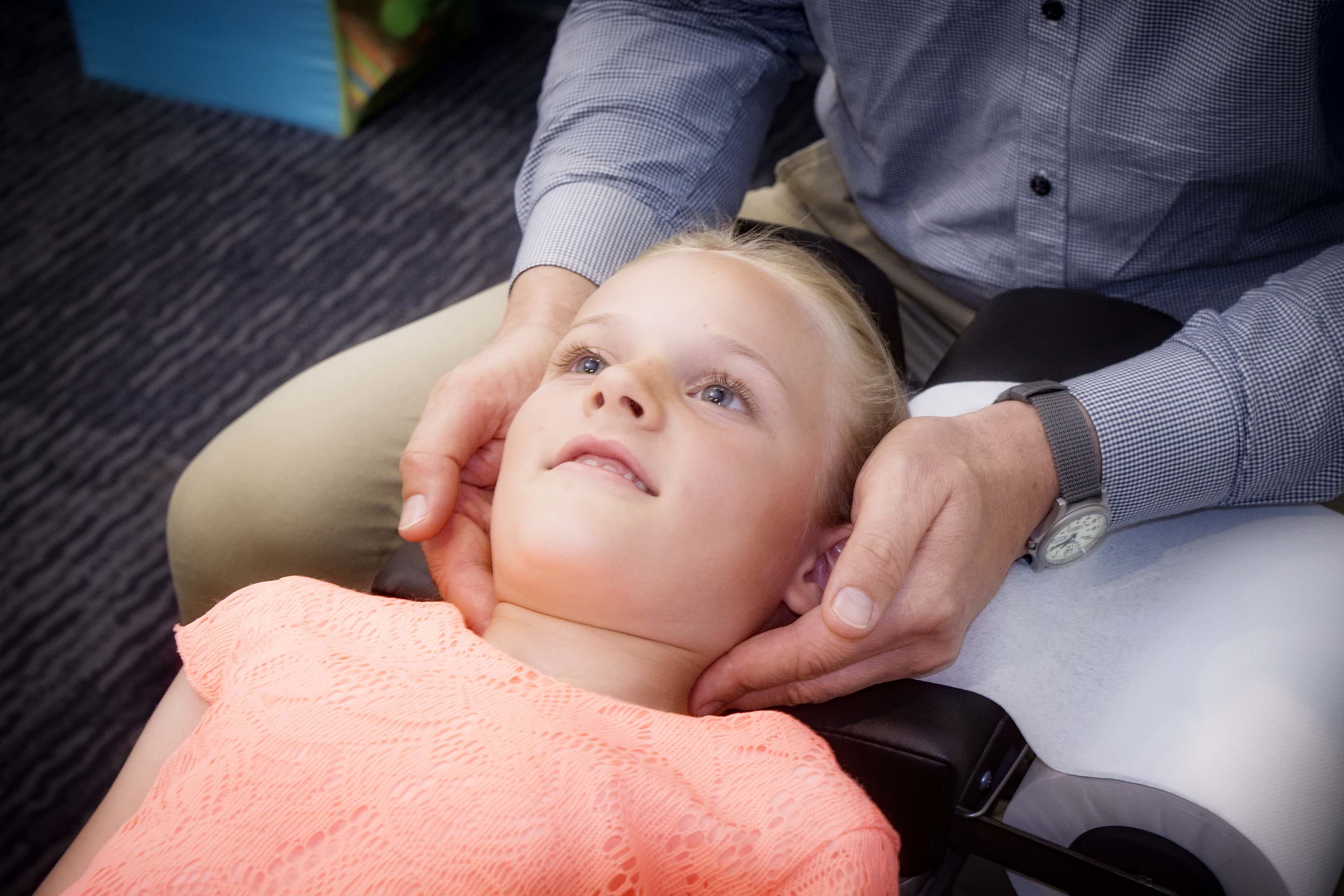 Dr Andrian Turczynowicz, chiropractor treating a female child at Chiropractic Solutions Norwood Adelaide